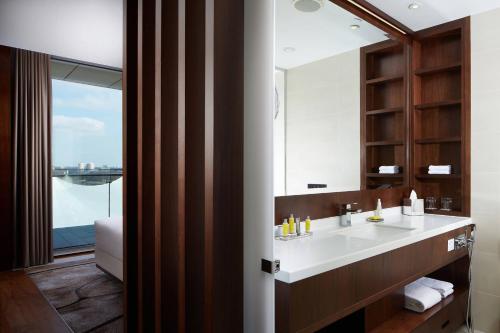 a bathroom with a sink and a large window at Minsk Marriott Hotel in Minsk