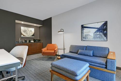 a living room with a couch and a chair at Courtyard by Marriott Hamilton in Hamilton