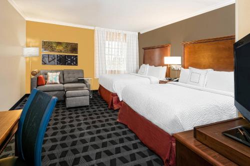 a hotel room with two beds and a television at TownePlace Suites by Marriott San Antonio Northwest in San Antonio