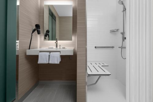 a bathroom with a sink and a shower at AC Hotel By Marriott Miami Brickell in Miami
