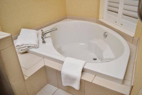 a white bath tub in a bathroom with towels at Fairfield Inn & Suites Effingham in Effingham