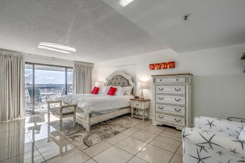 a bedroom with a bed and a dresser and a window at Forest Dunes Penthouse 1801 in Myrtle Beach