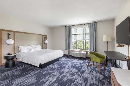 a hotel room with a bed and a desk at Fairfield Inn & Suites by Marriott Minneapolis North/Blaine in Blaine