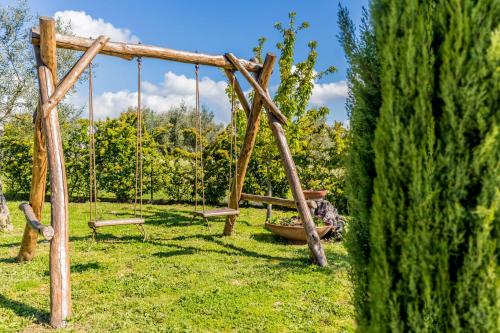 a wooden swing set in a grassy field at B&B A casa di Giulia in Guidonia