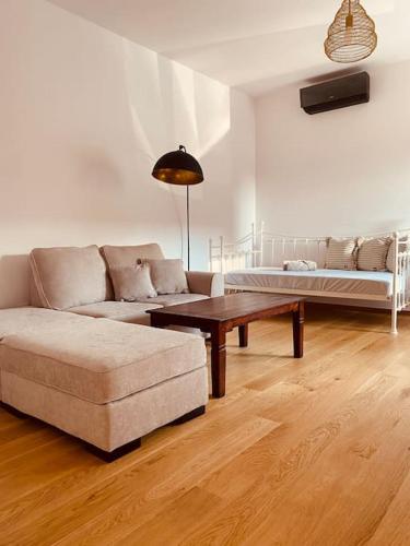 a living room with a couch and a coffee table at Dvojizbový apartmán v blízskom centre Bardejova in Bardejov