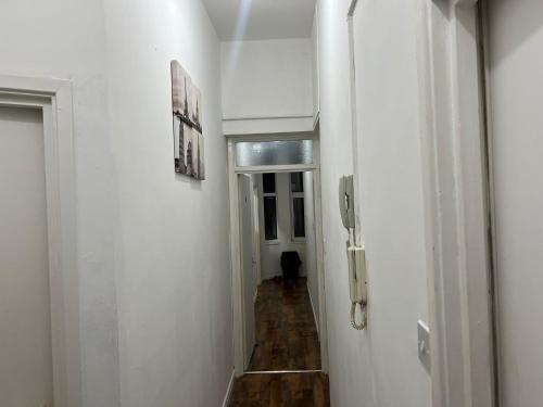 a hallway with white walls and a phone on the wall at ☆ Property Buzzer Serviced Apartments ☆ 1 Bed Flat Birmingham City Centre - China Town ☆ Very close to Bull Ring, Grand Central + Mailbox ☆ in Birmingham