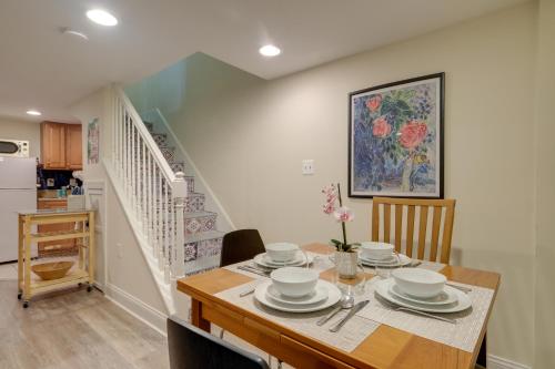 a dining room with a table with dishes on it at Washington DC Apartment at Rock Creek Park! in Washington, D.C.