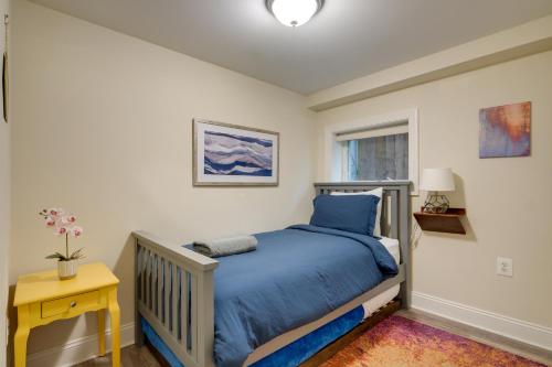 a bedroom with a blue bed and a yellow table at Washington DC Apartment at Rock Creek Park! in Washington, D.C.