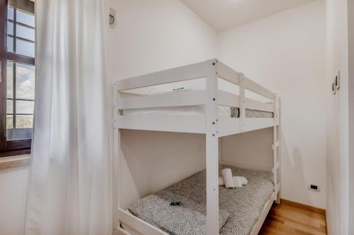 a white bunk bed in a room with a window at B&B A casa di Giulia in Guidonia