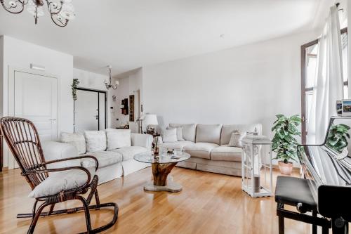 a living room with a white couch and a table at B&B A casa di Giulia in Guidonia