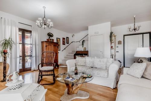 a living room with a white couch and a table at B&B A casa di Giulia in Guidonia