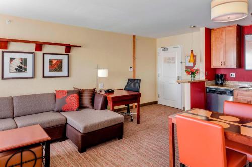 a living room with a couch and a table at Residence Inn by Marriott Auburn in Auburn