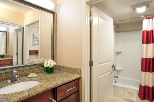 a bathroom with a sink and a mirror and a shower at Residence Inn by Marriott Auburn in Auburn