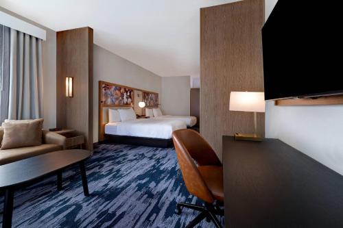a hotel room with a bed and a desk at Fairfield by Marriott Inn & Suites St. Paul Eagan in Eagan