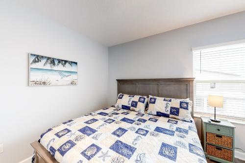 a white bedroom with a bed and a window at Casa De Playa in Melbourne Beach