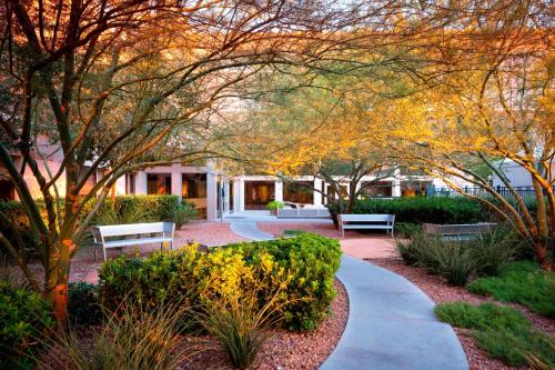 a garden with benches and trees and a building at Element Las Vegas Summerlin in Las Vegas