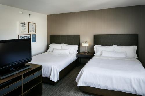 a hotel room with two beds and a flat screen tv at Element Las Vegas Summerlin in Las Vegas