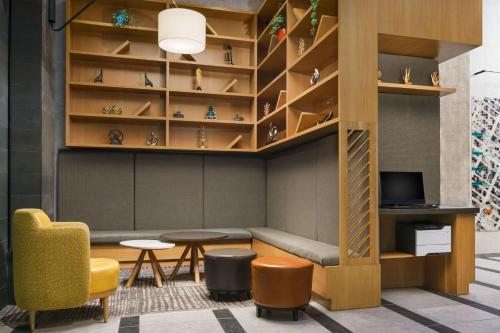 a room with a couch and a table and shelves at TownePlace Suites by Marriott New York Manhattan/Chelsea in New York