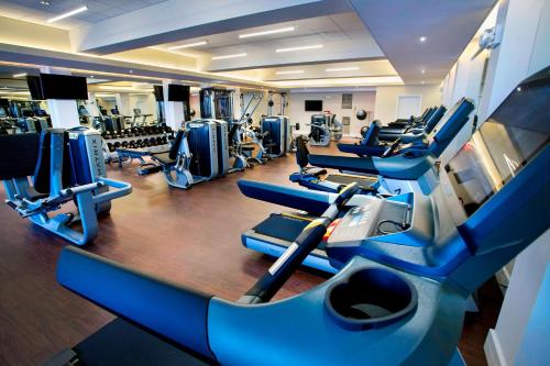 a gym with rows of treadmills and machines at New York Marriott Downtown in New York