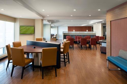 a waiting room with a table and chairs in a hospital at TownePlace Suites Fresno Clovis in Clovis