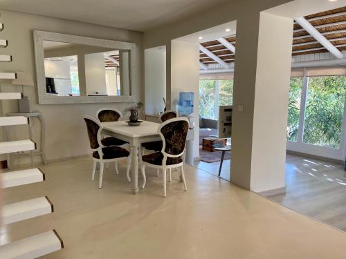 a dining room with a white table and chairs at Finca El Cañuelo in Bolonia