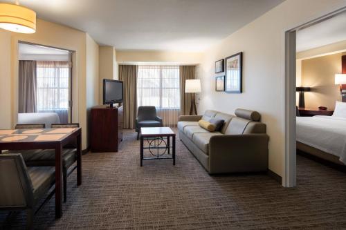 a hotel room with a couch and a bed at Residence Inn by Marriott Camarillo in Camarillo