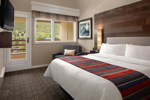 a hotel room with a bed and a chair and a window at Marriott's StreamSide Douglas at Vail in Vail