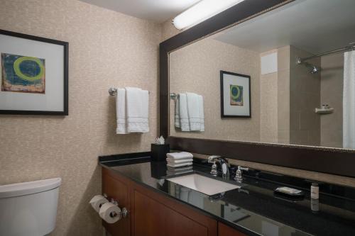 a bathroom with a sink and a large mirror at Sheraton Kansas City Hotel at Crown Center in Kansas City