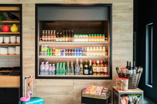 a refrigerator filled with different types of drinks at Moxy Paris Val d'Europe in Montévrain