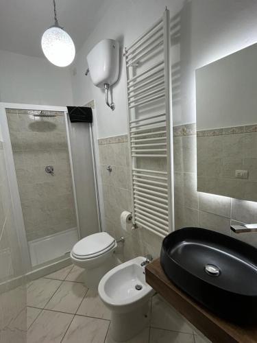 a bathroom with a black sink and a toilet at SognoNarni in Narni