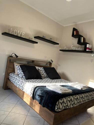 a bed in a room with shelves on the wall at SognoNarni in Narni