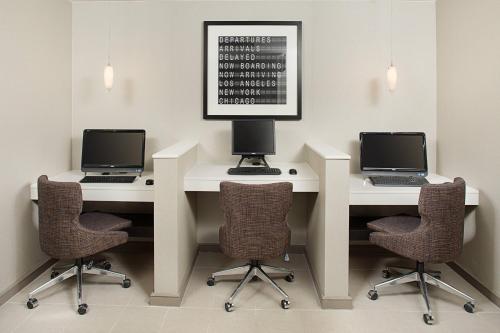 two desks with laptops and chairs in a room at Residence Inn Chicago O'Hare in Rosemont