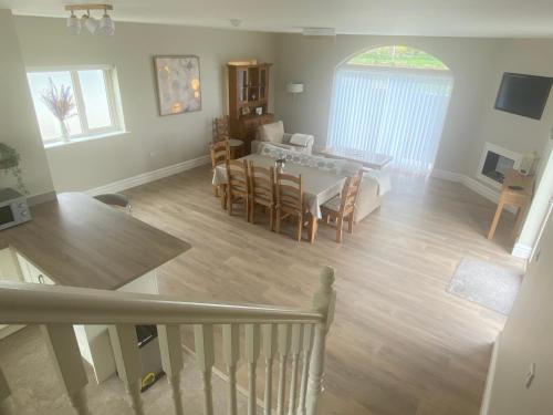 a living room and dining room with a table and chairs at Ard Alainn Lodge, Adorable Setting, scenic views in Grange