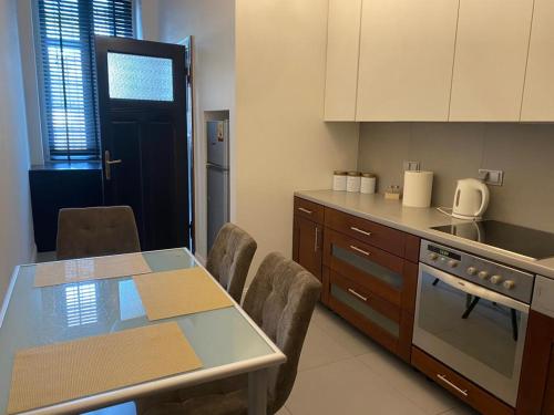 a kitchen with a table and chairs and a counter at Apt * Stella in Wrocław