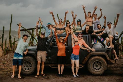 a group of people standing in front of a truck at Sansara Surf Yoga & Resort in Cambutal
