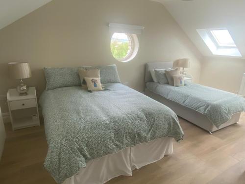 a bedroom with two beds and a window at Ard Alainn Lodge, Adorable Setting, scenic views in Grange