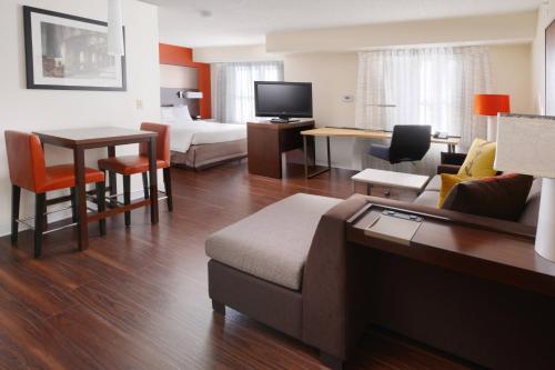 a hotel room with a couch and a bed and a table at Residence Inn by Marriott San Antonio Airport/Alamo Heights in San Antonio