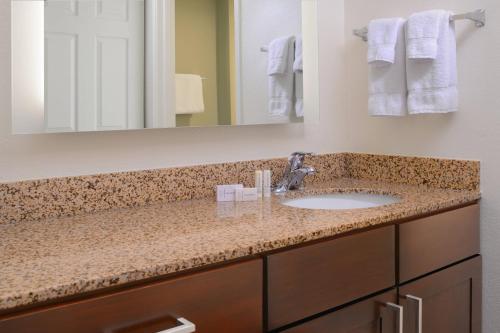 a bathroom with a sink and a mirror at Residence Inn by Marriott San Antonio Airport/Alamo Heights in San Antonio