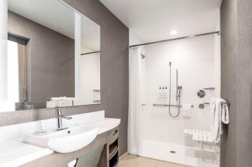 a white bathroom with a sink and a shower at SpringHill Suites by Marriott San Jose Fremont in Fremont