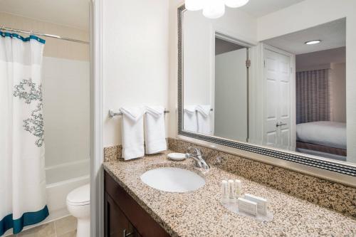 a bathroom with a sink and a mirror at Residence Inn Costa Mesa Newport Beach in Costa Mesa