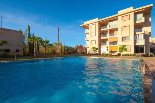 a large swimming pool in front of a building at La Vita Moderna - Private Pool in Marrakech