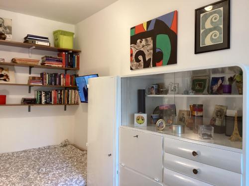 a room with a white dresser and bookshelves at Apartment Punta in Pula