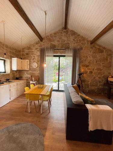 a living room with a couch and a table and a kitchen at Casa de Morão in Viana do Castelo