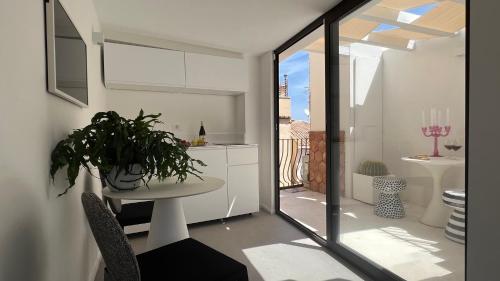 a kitchen with a table with a plant on it at Terme Luxury Suite in Taormina