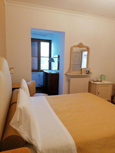 a bedroom with a large bed and a mirror at Agriturismo Salinola in Ostuni