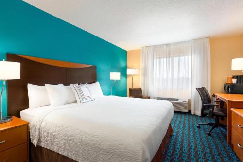 ein Hotelzimmer mit einem großen Bett und einem Fenster in der Unterkunft Fairfield Inn & Suites Saginaw in Saginaw