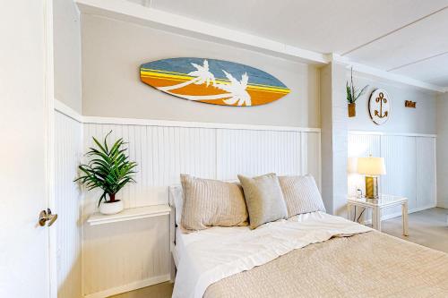 a bedroom with a surfboard hanging on the wall at 7213 Flood Reef - Unit 4 in Pensacola