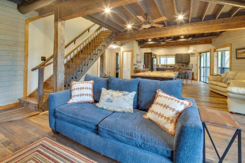a blue couch in a living room with a staircase at Rustic-Chic Sapphire Home with Wraparound Decks in Sapphire