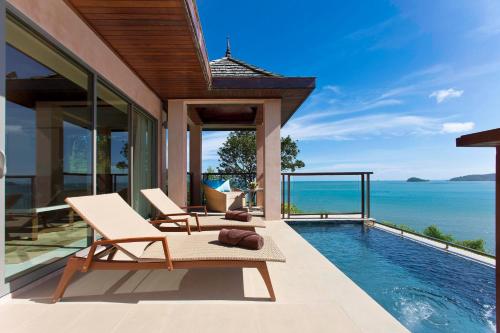 a villa with a swimming pool with a view of the ocean at The Westin Siray Bay Resort & Spa, Phuket in Phuket