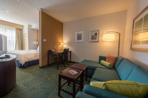 a hotel room with a couch and a bed at SpringHill Suites Ridgecrest in Ridgecrest